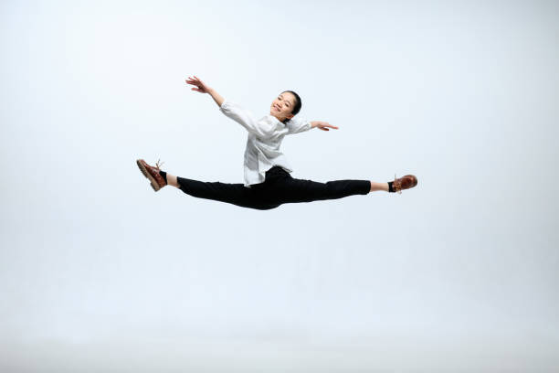 istock Woman working at office and jumping isolated on studio background 1141209918