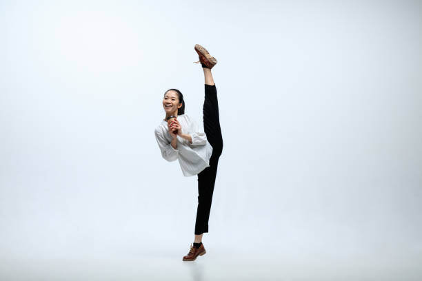 istock Woman working at office and jumping isolated on studio background 1141209930