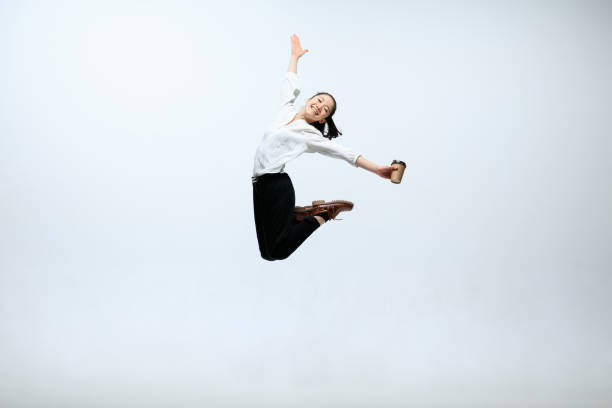 istock Woman working at office and jumping isolated on studio background 1141209932