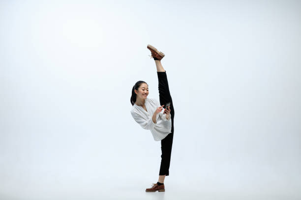 istock Woman working at office and jumping isolated on studio background 1141209958