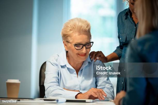 Expertise Discussing New Plans With Businesswomen Stock Photo - Download Image Now - 35-39 Years, 40-44 Years, 70-79 Years