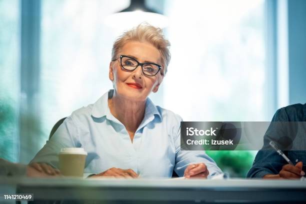 Portrait Of Senior Professional Working In Office Stock Photo - Download Image Now - Owner, 70-79 Years, Active Seniors