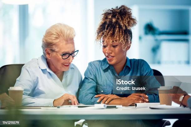 Smiling Businesswomen Working In New Office Stock Photo - Download Image Now - Advice, Smiling, 35-39 Years