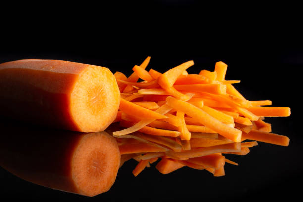 istock Fresh orange carrot isolated on black glass 1141211534