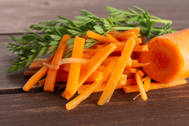 istock Fresh orange carrot on brown wood 1141211629