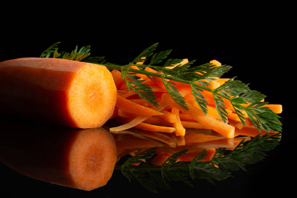 istock Fresh orange carrot isolated on black glass 1141211636