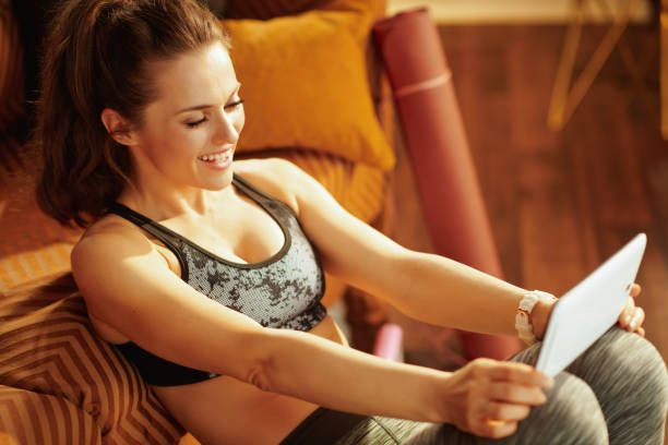 istock sports woman using online fitness training program in tablet PC 1141211701