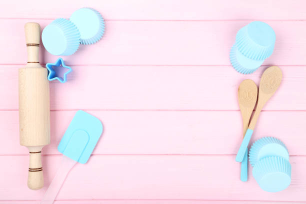 istock Cupcake cases with kitchen utensils on pink wooden table 1141212945