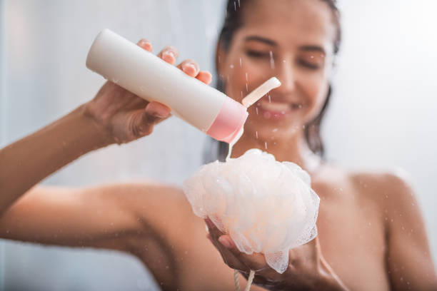 Glad female pressing liquid onto bath sponge Outgoing girl putting shower gel on puff. She taking hot shower Soft Gel stock pictures, royalty-free photos & images