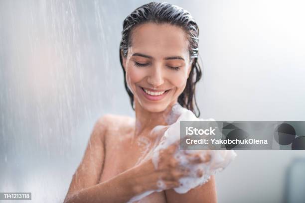 Smiling Female Rubbing Body With Foam Stock Photo - Download Image Now - Shower, Women, One Woman Only