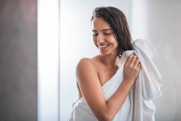 Happy girl touching head with arms stock photo