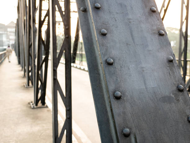 The Beams of The Iron Bridge Lined Long until The Man Walking on The Leaf
