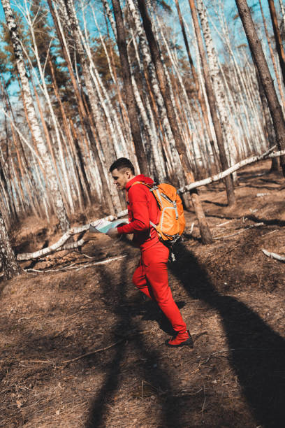 istock Traveling man with map in woods 1141215449