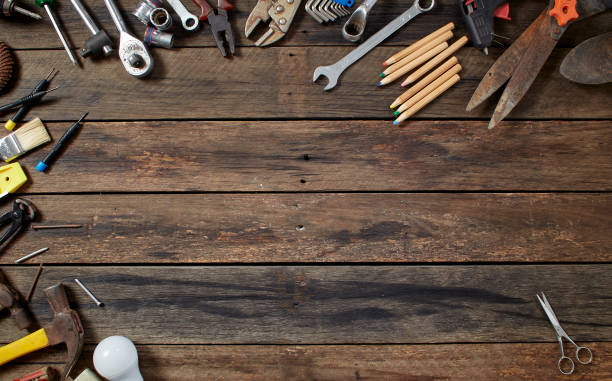 istock tools on a dark wooden table. Place for the text 1141215668