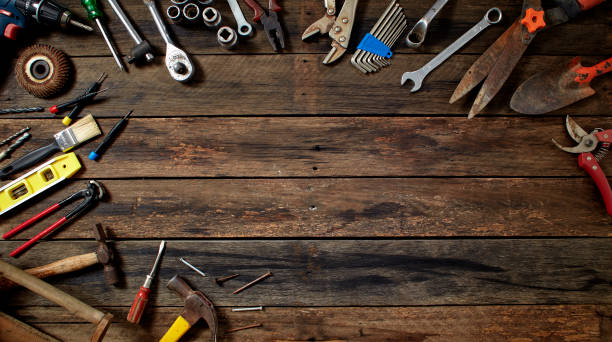 istock tools on a dark wooden table. Place for the text 1141215676