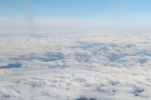 Overhead view of countryside from high up above clouds