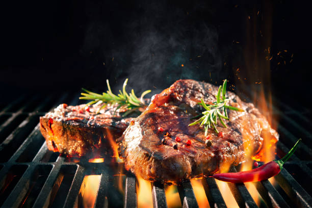istock Beef steaks sizzling on the grill 1141217310