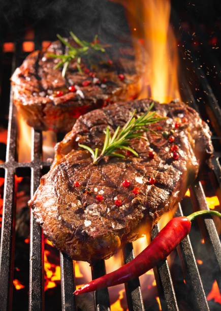 istock Beef steaks sizzling on the grill 1141217314