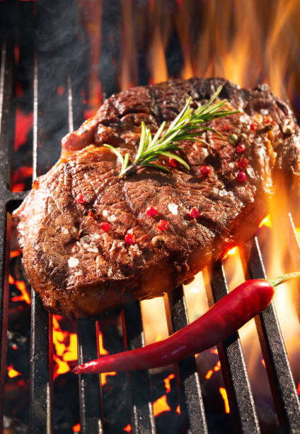 istock Beef steak sizzling on the grill 1141217315