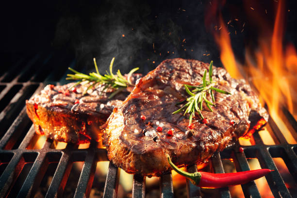 istock Beef steaks sizzling on the grill 1141217316