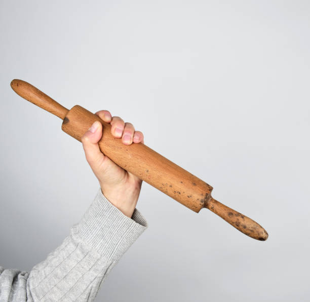istock hand holding a wooden rolling pin 1141217697