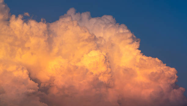 istock Blue sky and white fluffy clouds on sunset sky. White cumulus clouds. Dramatic sky and clouds abstract background. Warm weather background. Art picture of clouds at dusk. Cloudy sky. 1141219563