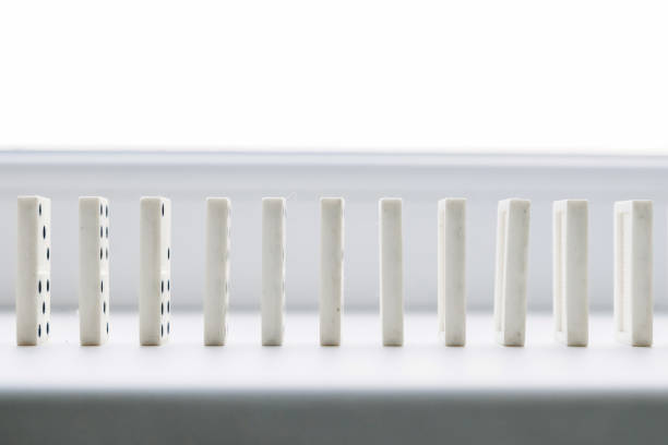 istock White domino, domino principle, on white background 1141219646