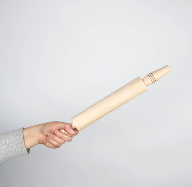istock hand holding a wooden rolling pin 1141219860