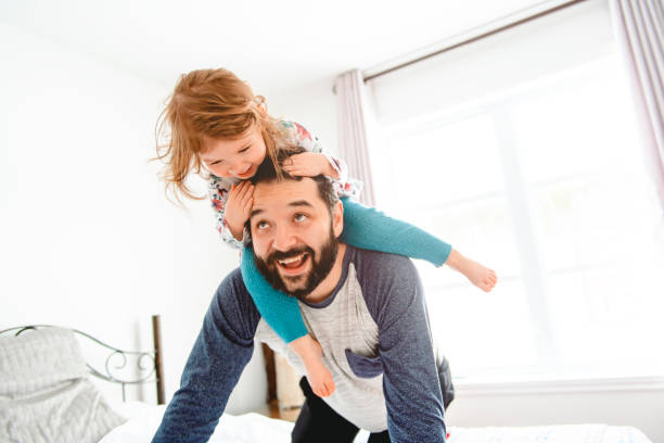 istock A Nice father with girl child on bed 1141220041