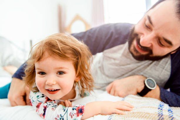 istock A Nice father with girl child on bed 1141220046