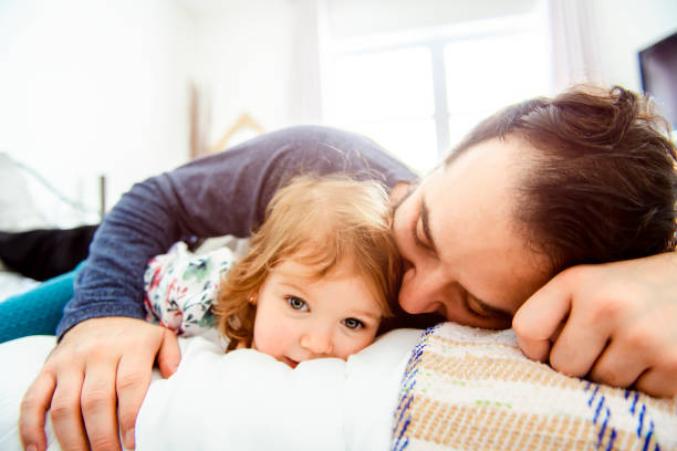 istock A Nice father with girl child on bed 1141220146