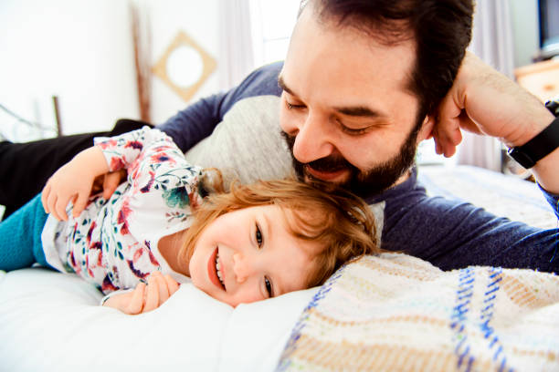 istock A Nice father with girl child on bed 1141220182