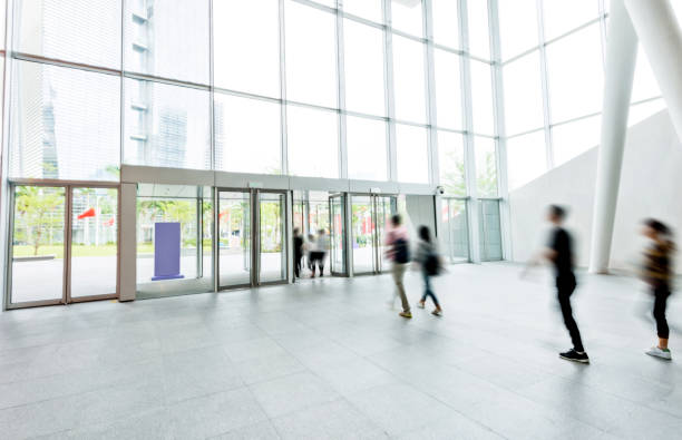 istock Group of people walking in modern building lobby 1141220532