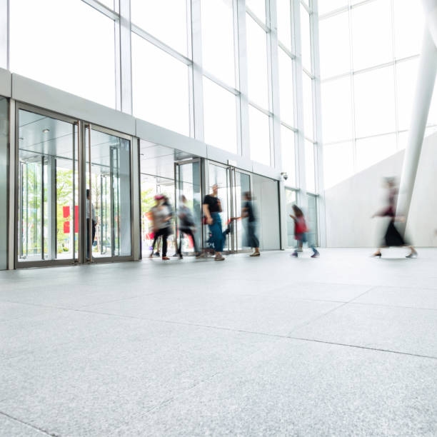 istock Group of people walking in modern building lobby 1141220588