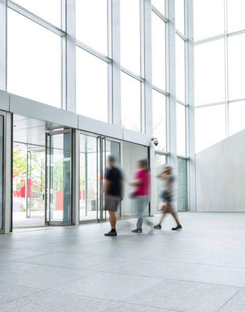 istock Group of people walking in modern building lobby 1141221525