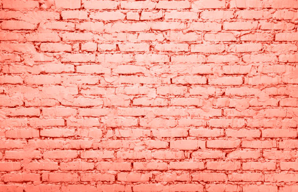 istock Coral pink toned brick wall background texture 1141221774