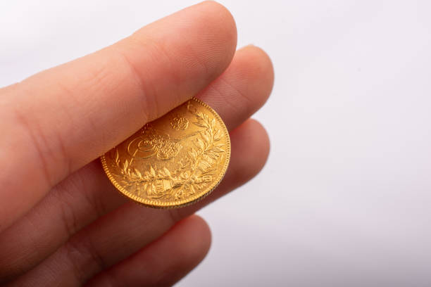 istock Turkish Ottoman style gold coin in hand 1141222734