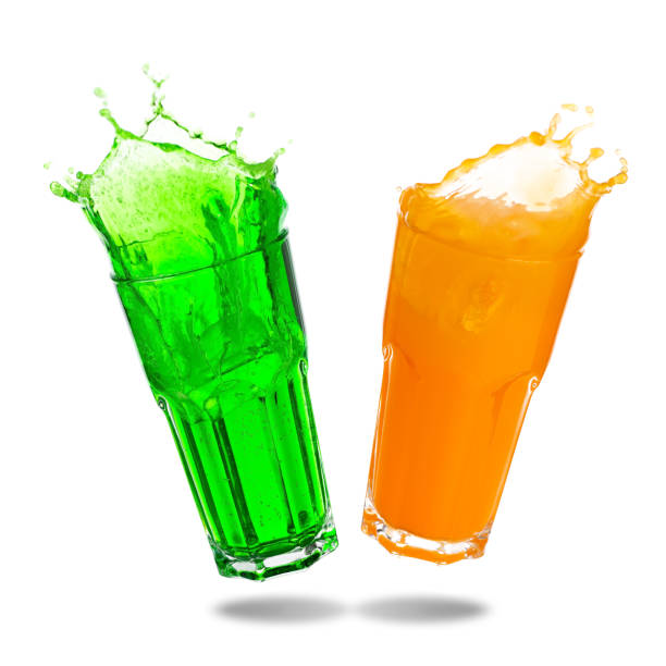 Soft drinks splashing Couple orange juice and green soda splashing out of glass isolated on white background. melon photos stock pictures, royalty-free photos & images