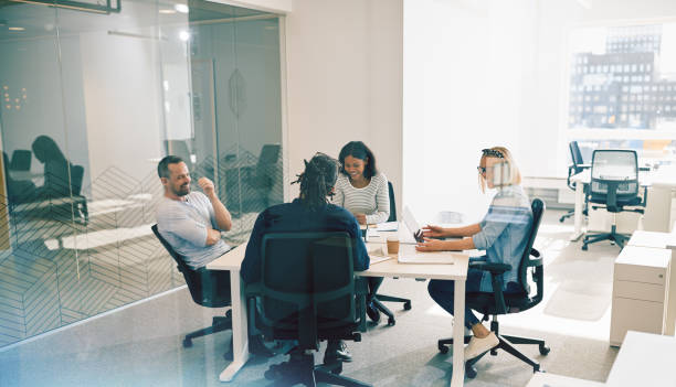 istock Laughing group of office colleagues having an work meeting together 1141223437