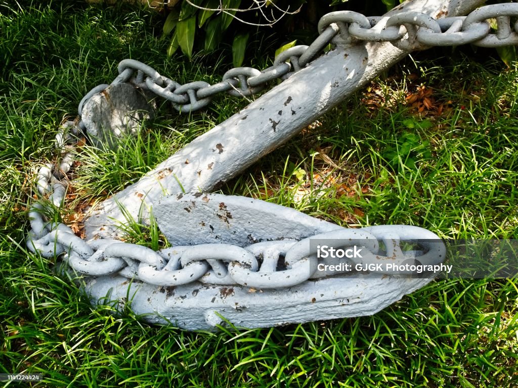 Ship Anchor in the Green Grass New Orleans, LA USA - 05/09/2018  -  Ship Anchor in the Green Grass Anchor - Vessel Part Stock Photo