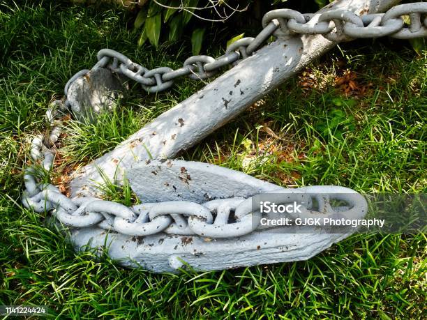 Ship Anchor In The Green Grass Stock Photo - Download Image Now - Anchor - Vessel Part, Yard - Grounds, Anchor Chain