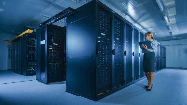 istock In Data Center Female IT Specialist Walks along the Row of Operational Server Racks, Checking Normal Functioning. Modern High-Tech Telecommunications Operational Data Center. 1141225026