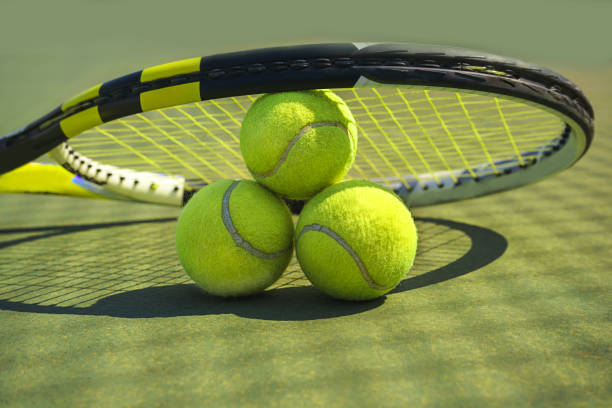 tennis balls and racket on the grass court. - playing field determination exercising relaxation exercise imagens e fotografias de stock