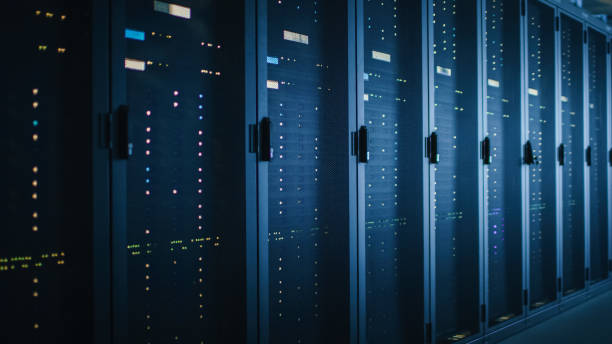 istock Shot of Dark Data Center With Multiple Rows of Fully Operational Server Racks. Modern Telecommunications, Cloud Computing, Artificial Intelligence, Database, Supercomputer. Blue Neon Light. 1141225052