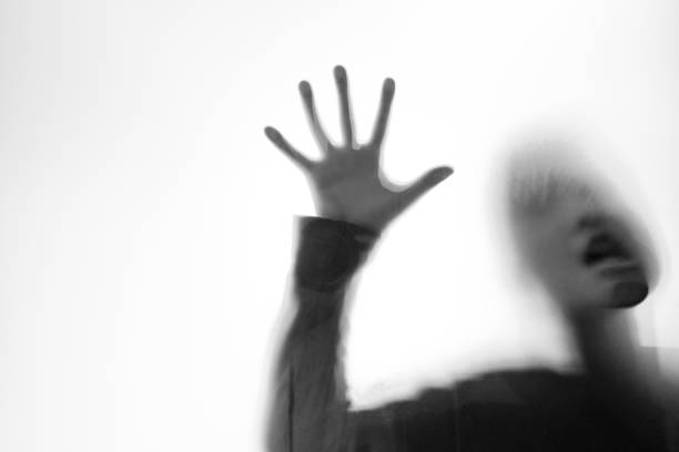 istock A boy trapping behind frosted glass 1141225218