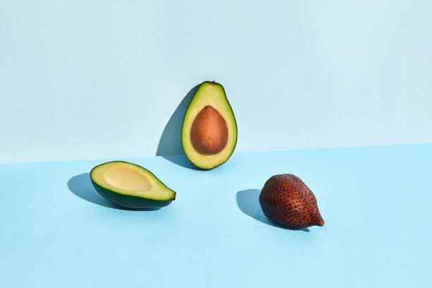 istock Avocado and Salacca fruits on blue background 1141226175