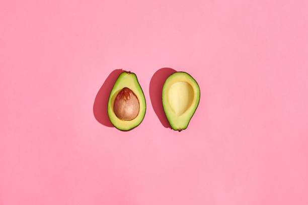 istock two half Avocado fruits on pink background 1141226176