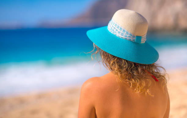 istock Beautiful woman sunbathing at beach on summer 1141226609