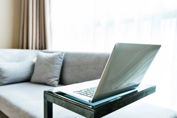 istock Laptop on table near gray sofa 1141226886