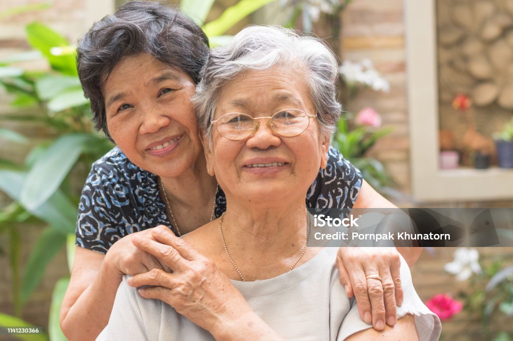Happy senior friendship society concept. Portrait of Asian female older ageing women smiling with happiness in garden at home, nursing home, or wellbeing county Senior Adult Stock Photo